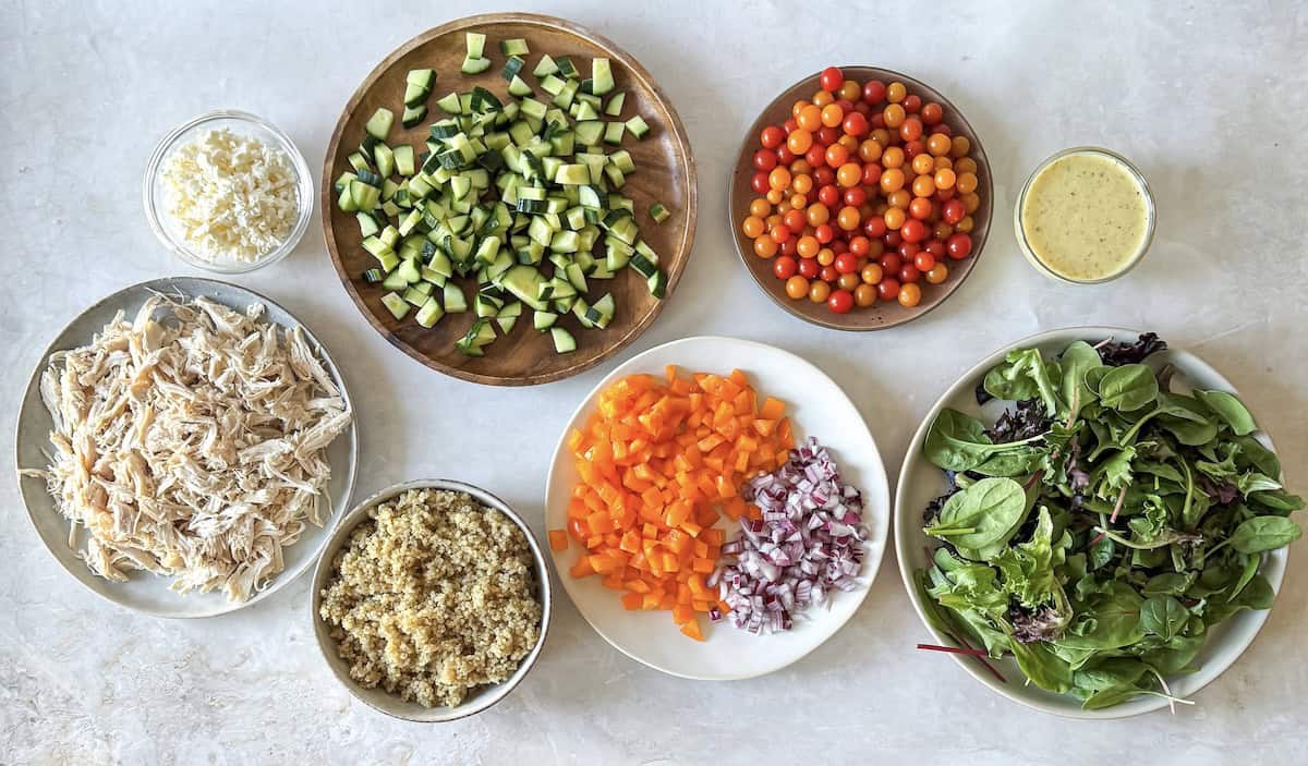 ingredients for mediteranean salad jar on a table.