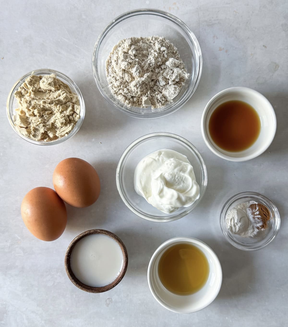 overhead view of ingredients for protein pancake bowl on a table.