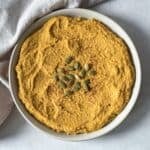 overhead view of pumpkin hummus on a plate.
