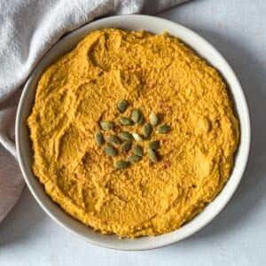 overhead view of pumpkin hummus on a plate.
