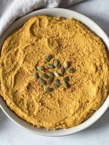 overhead view of pumpkin hummus on a plate.
