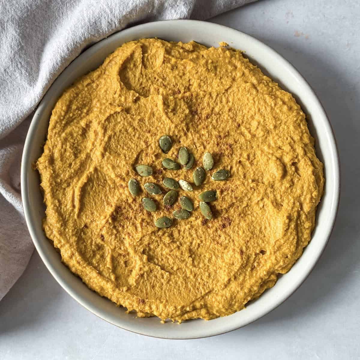 overhead view of pumpkin hummus on a plate.