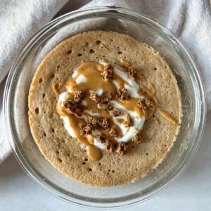 protein pancake bowl with greek yogurt, granola, and nut butter on top.