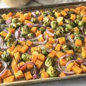 side view of fall roasted vegetables on a sheet pan.
