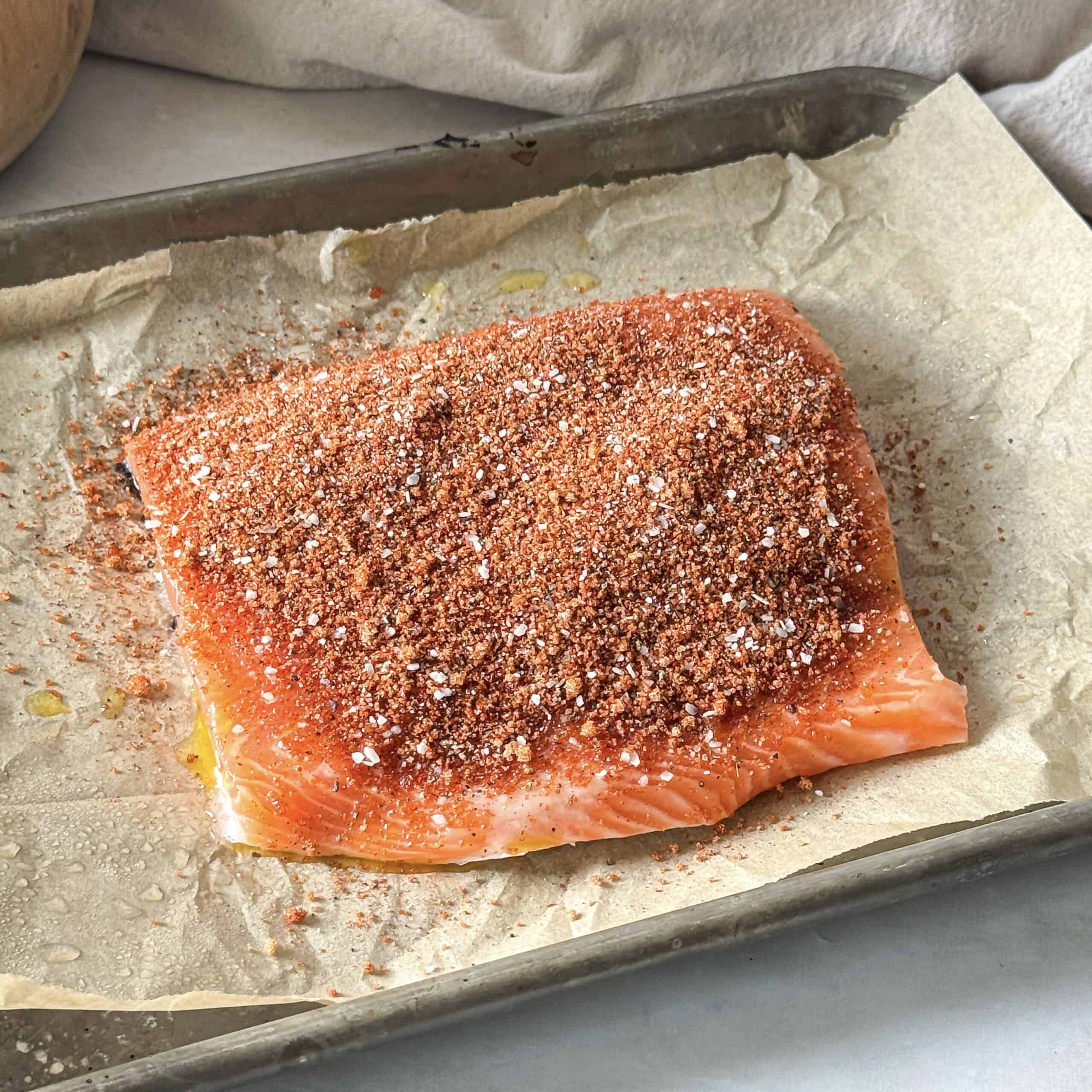 smoked paprika spice mixture on top of a salmon fillet.