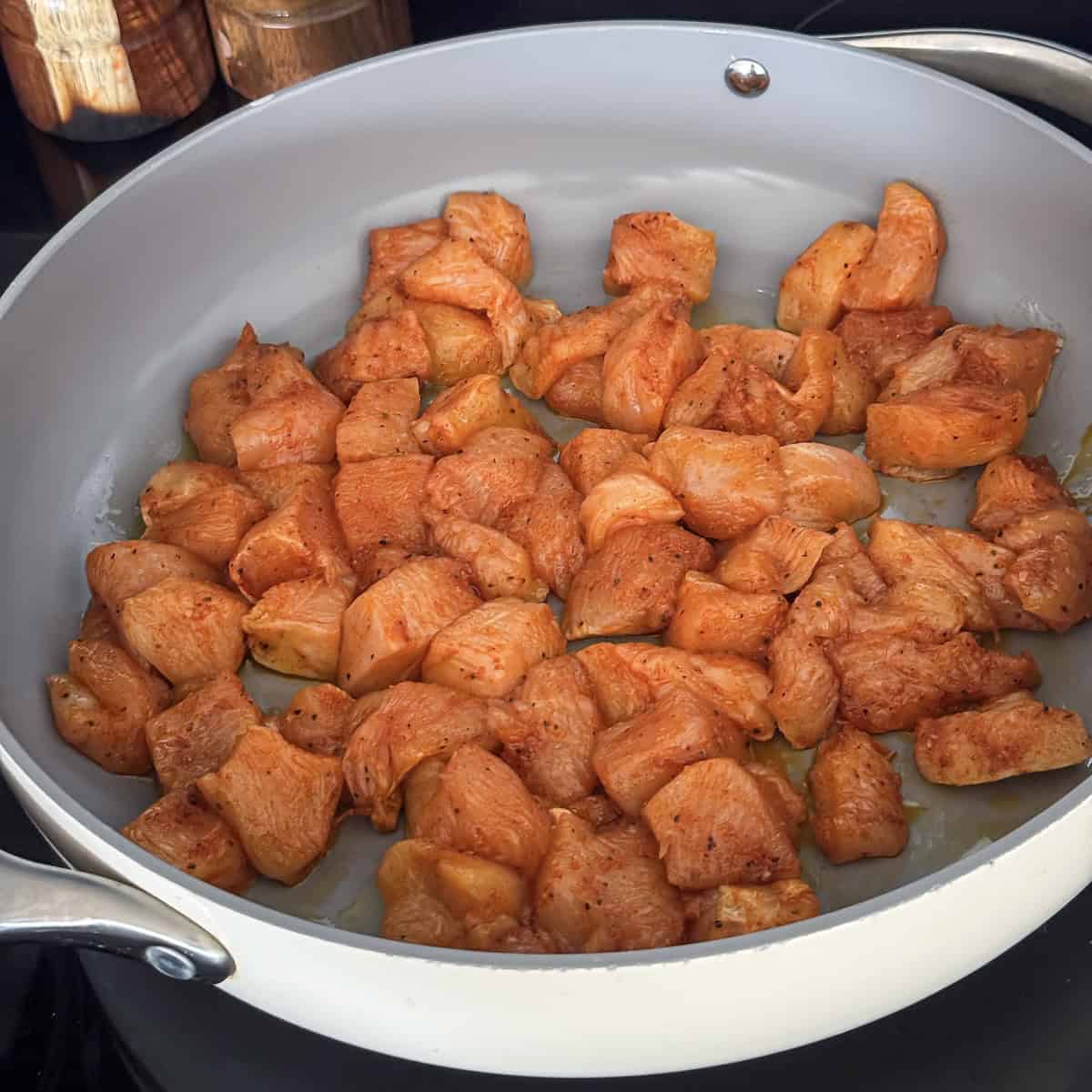 chicken being pan seared in a skillet.