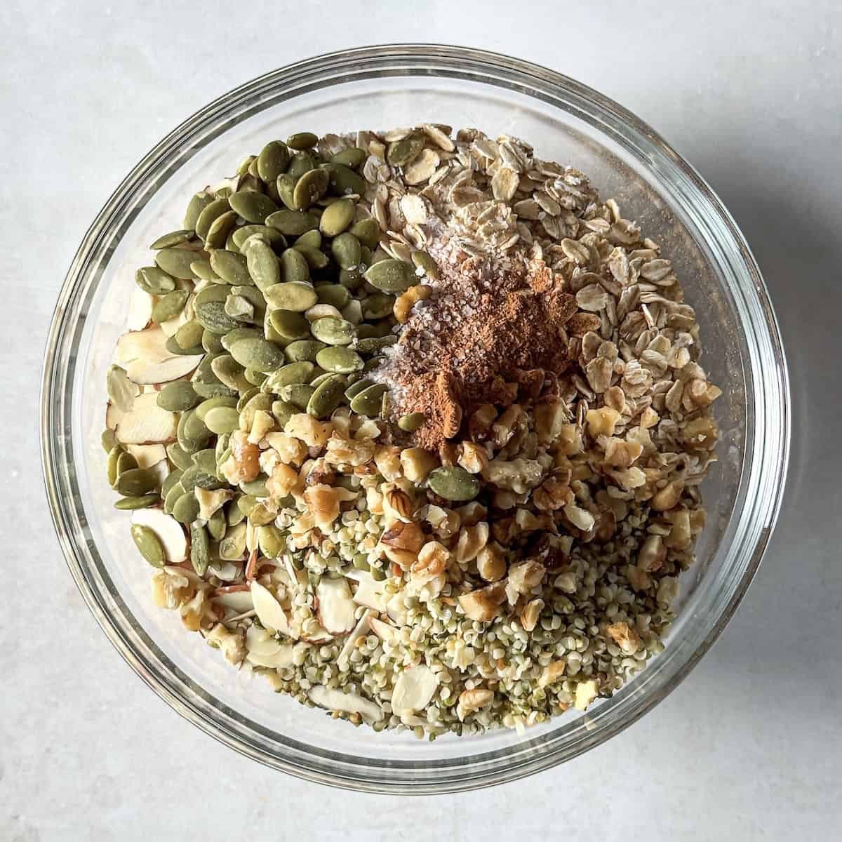 dry ingredients for homemade healthy granola in a glass bowl.