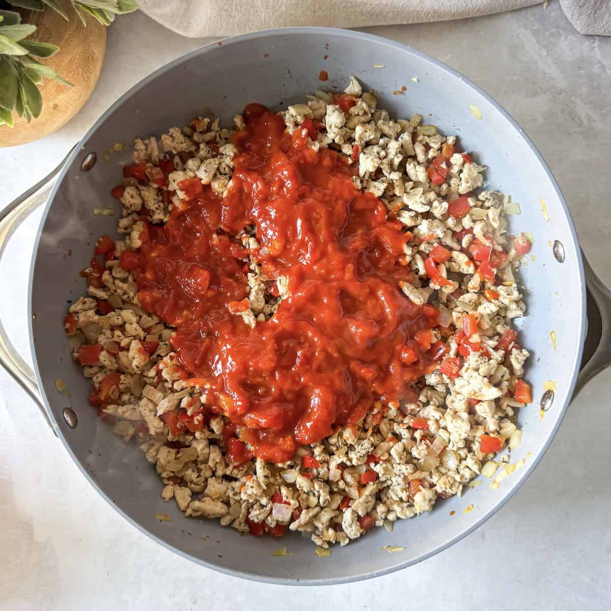 ground turkey and marinara sauce in a skillet.