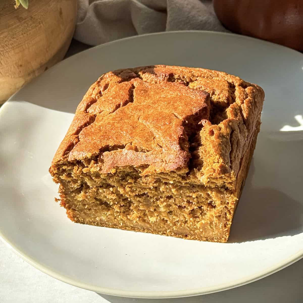half a loaf of banana pumpkin bread on a plate.