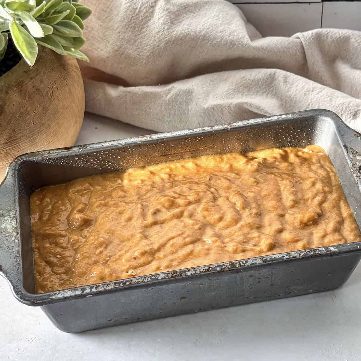 healthy pumpkin banana bread in a loaf pan.
