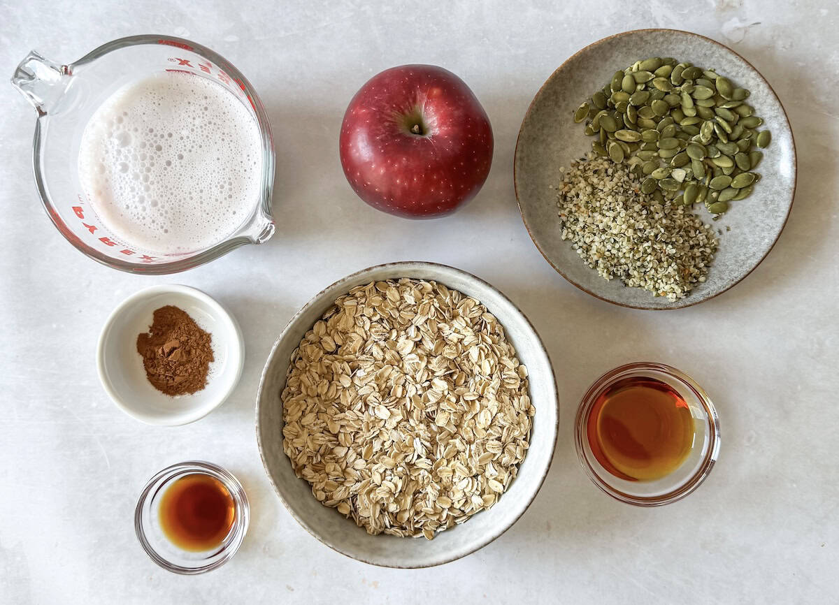 ingredients for apple cinnamon oatmeal on a table.