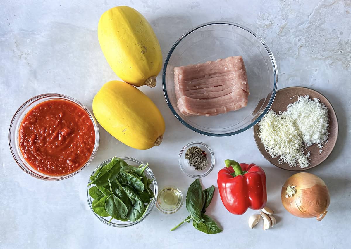 ingredients for spaghetti squash with meat sauce on a table.