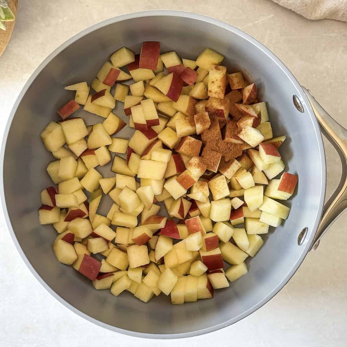 overhead view of apples with cinnamon on top.
