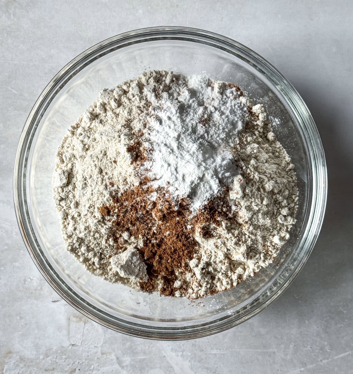 overhead view of dry ingredients for healthy banana pumpkin bread in a glass bowl.
