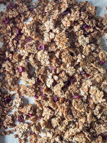 overhead view of healthy granola recipe on a sheet pan.