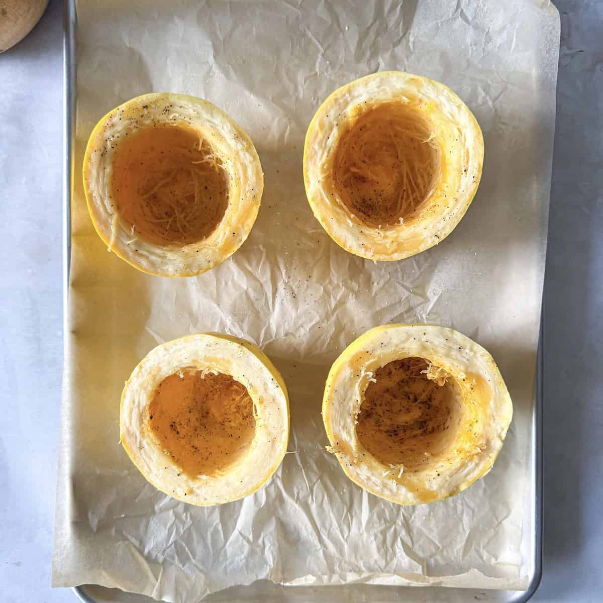overhead view of spaghetti squash on a baking sheet.