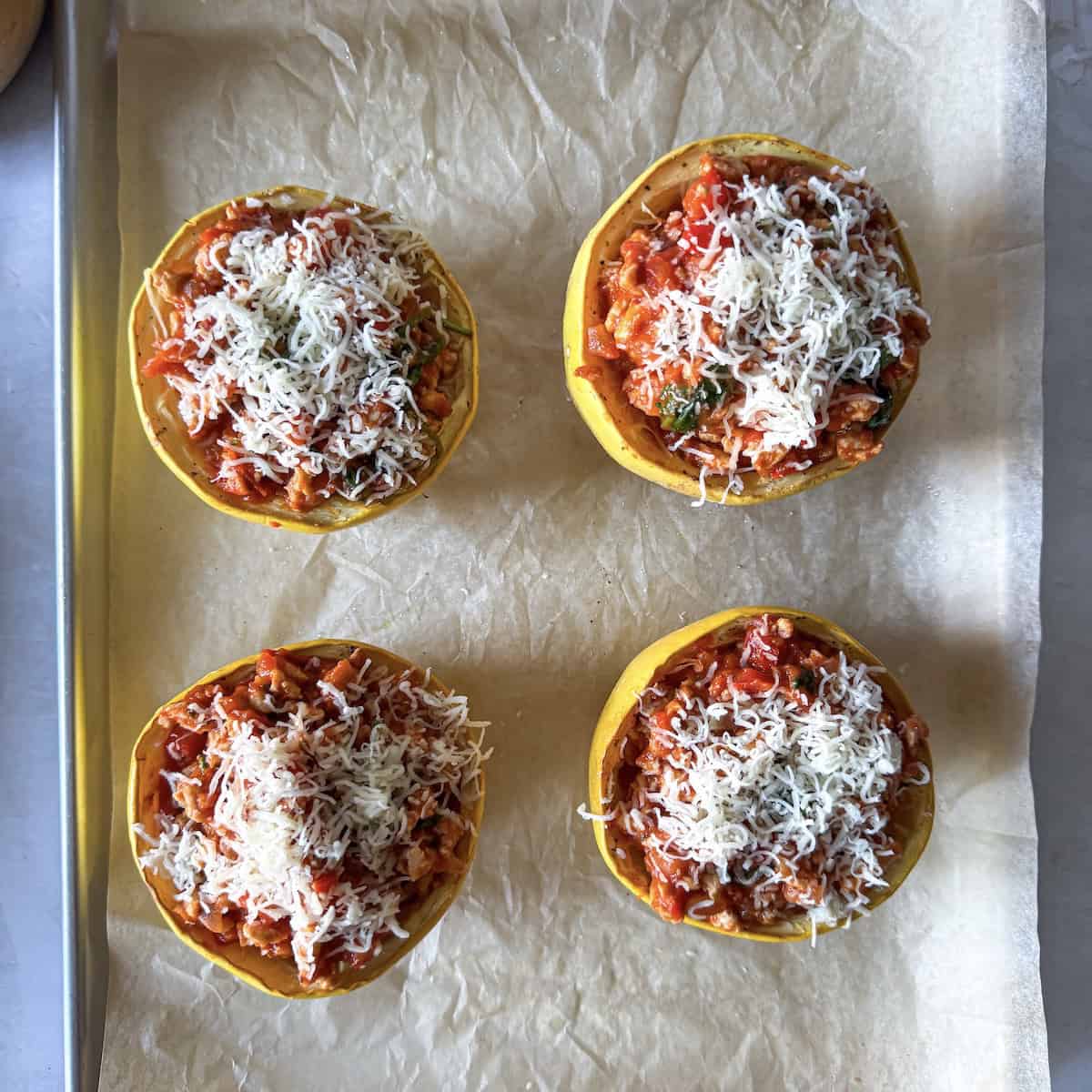 overhead view of spaghetti squash with meat sauce with cheese added on top.
