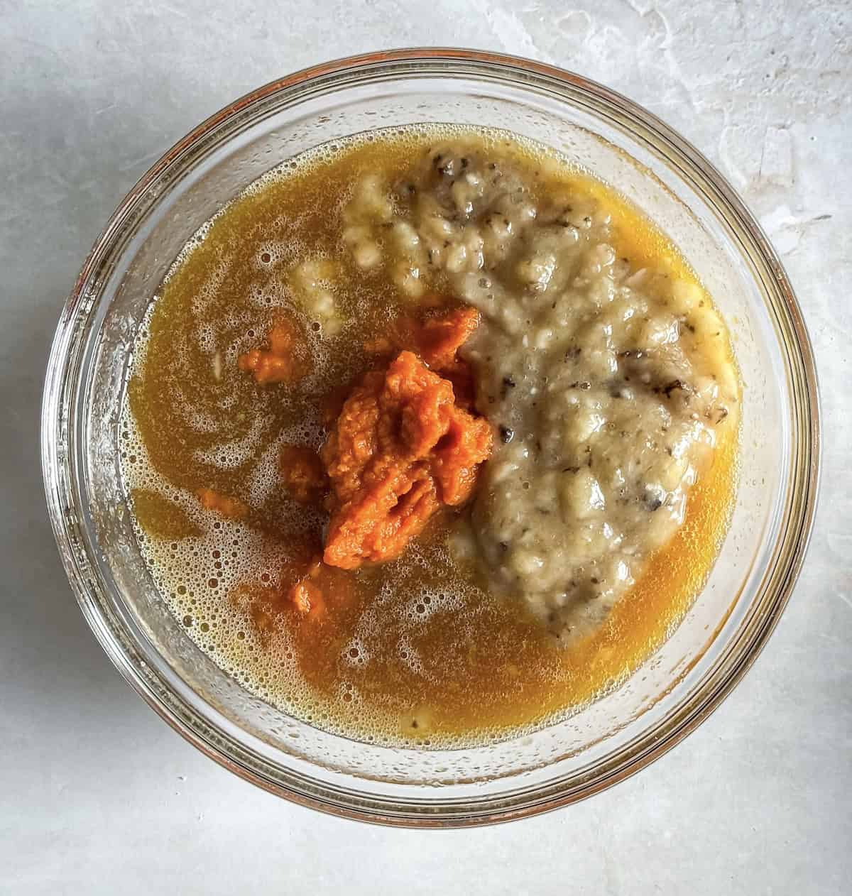 overhead view of wet ingredients for healthy pumpkin banana bread in a bowl, overhead view.