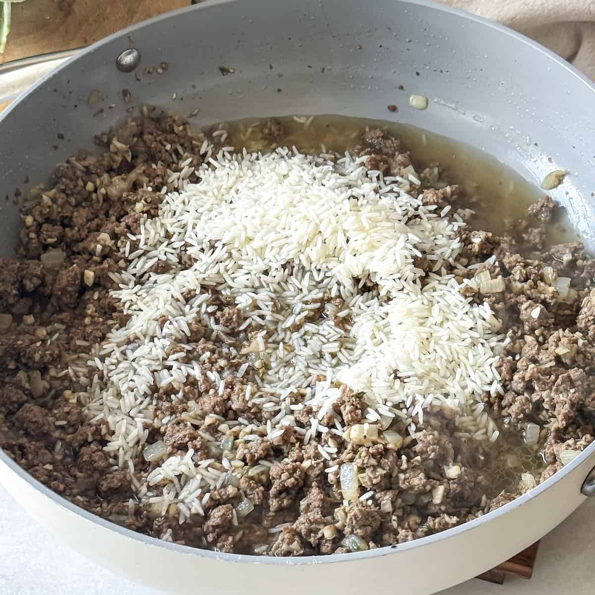 rice and broth added to skillet.