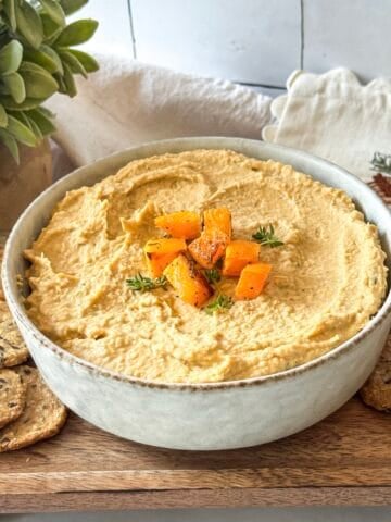 side view of butternut squash hummus with seed crackers.