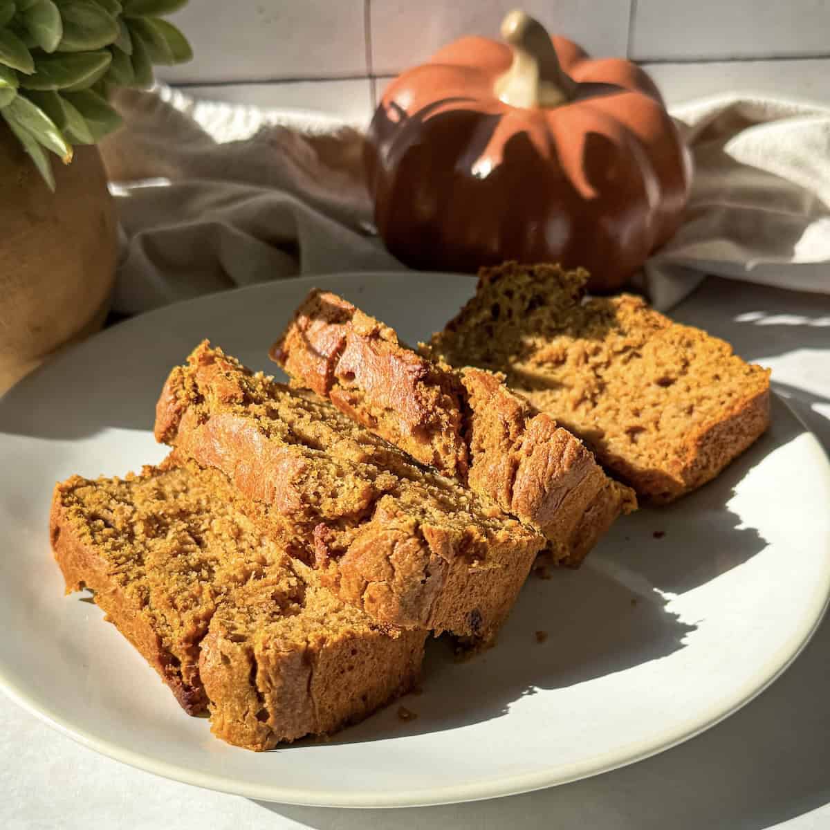 sliced healthy banana pumpkin bread on a plate.