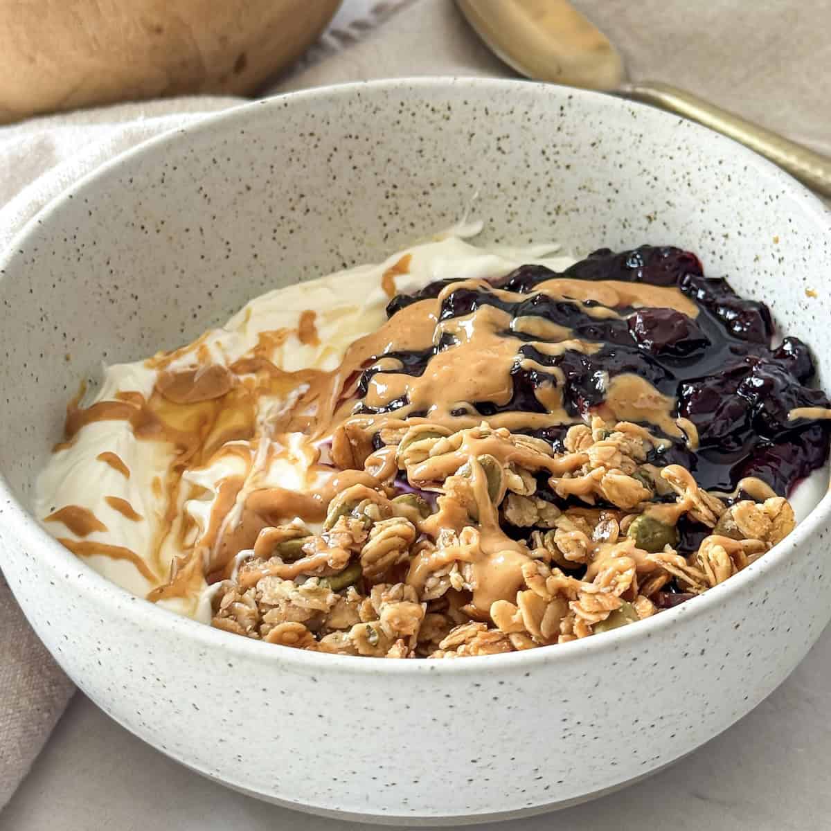 close up side view of greek yogurt bowl.