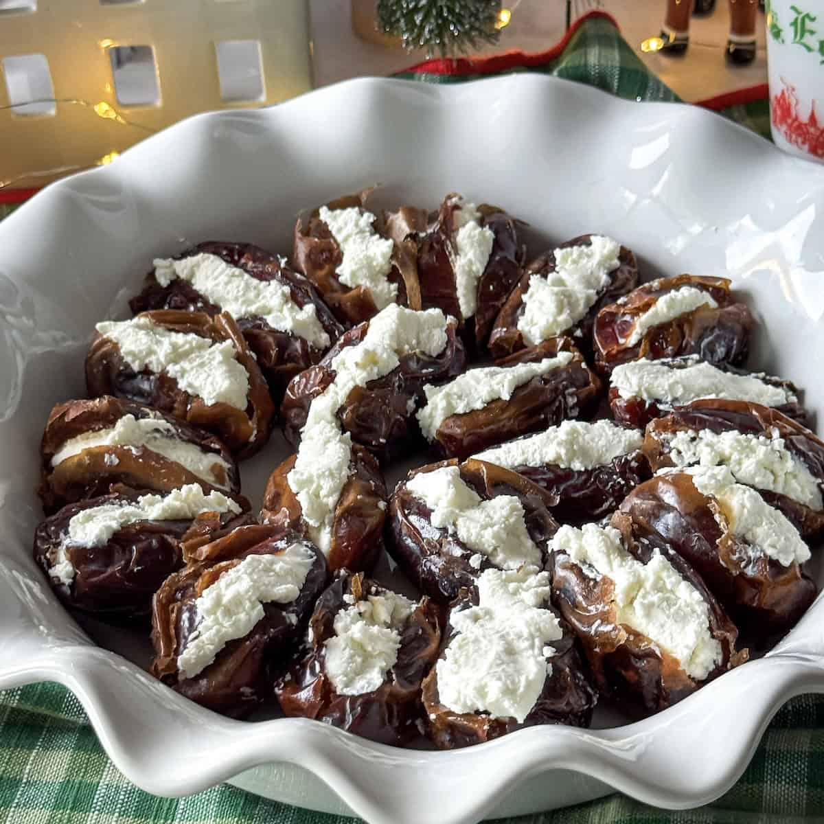 dates stuffed with goat cheese on a pie platter.