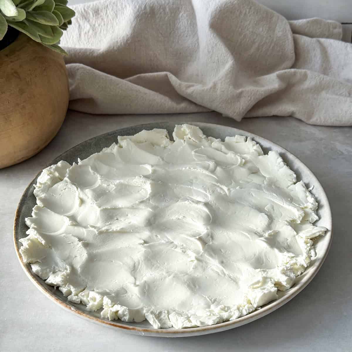 goat cheese spread on a plate.