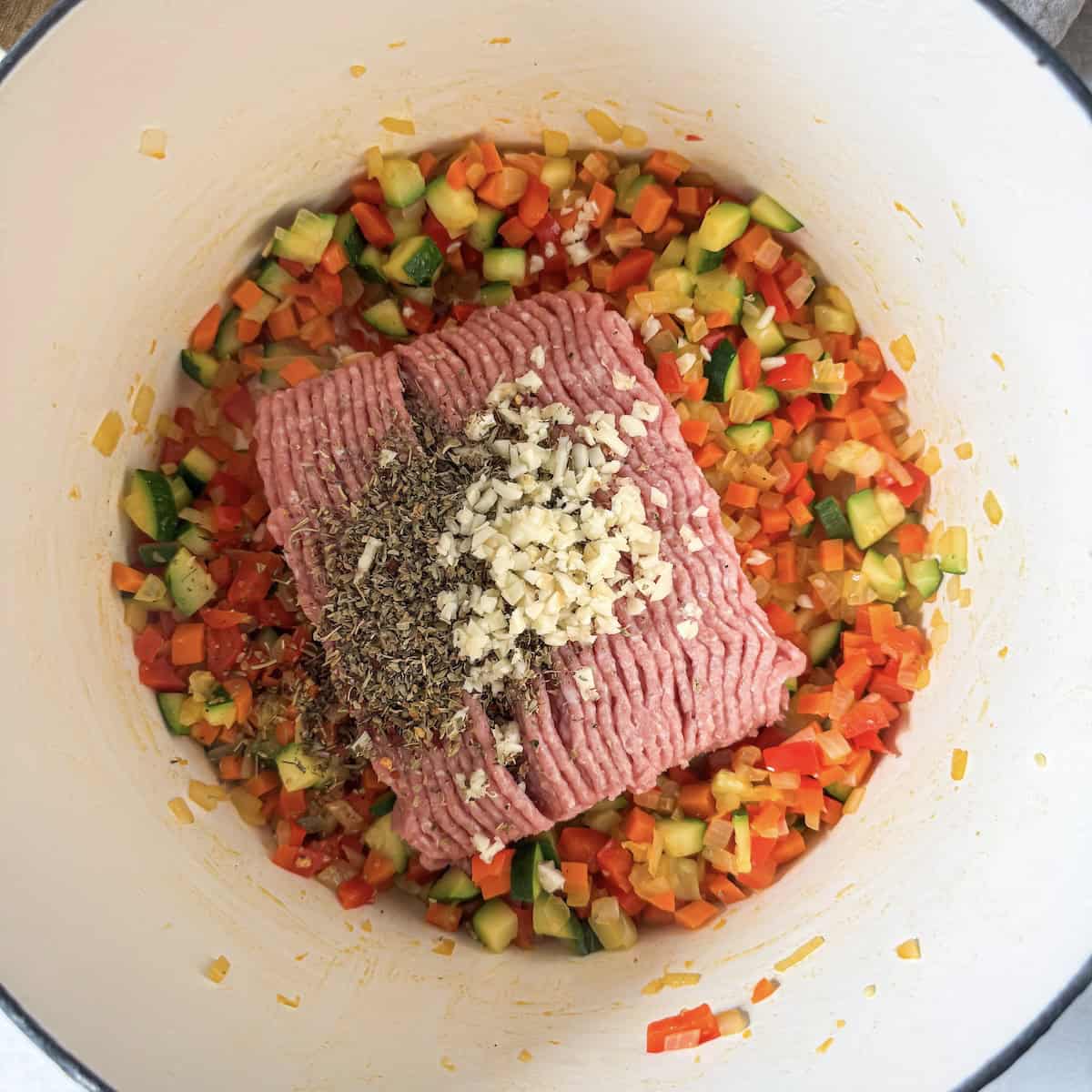 ground turkey added to vegetables.