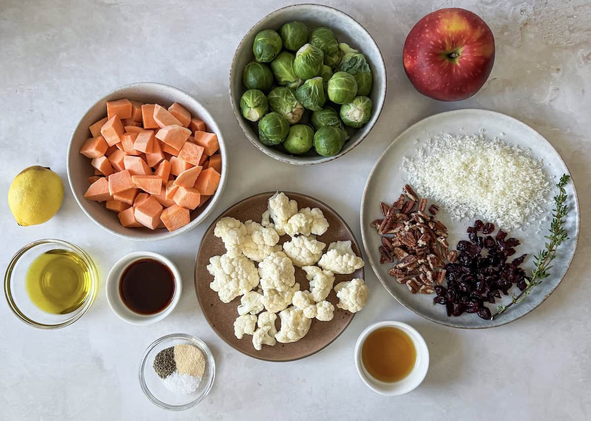 overhead view of ingredients for roasted brussels sprouts and sweet potatoes with cranberries and pecans.