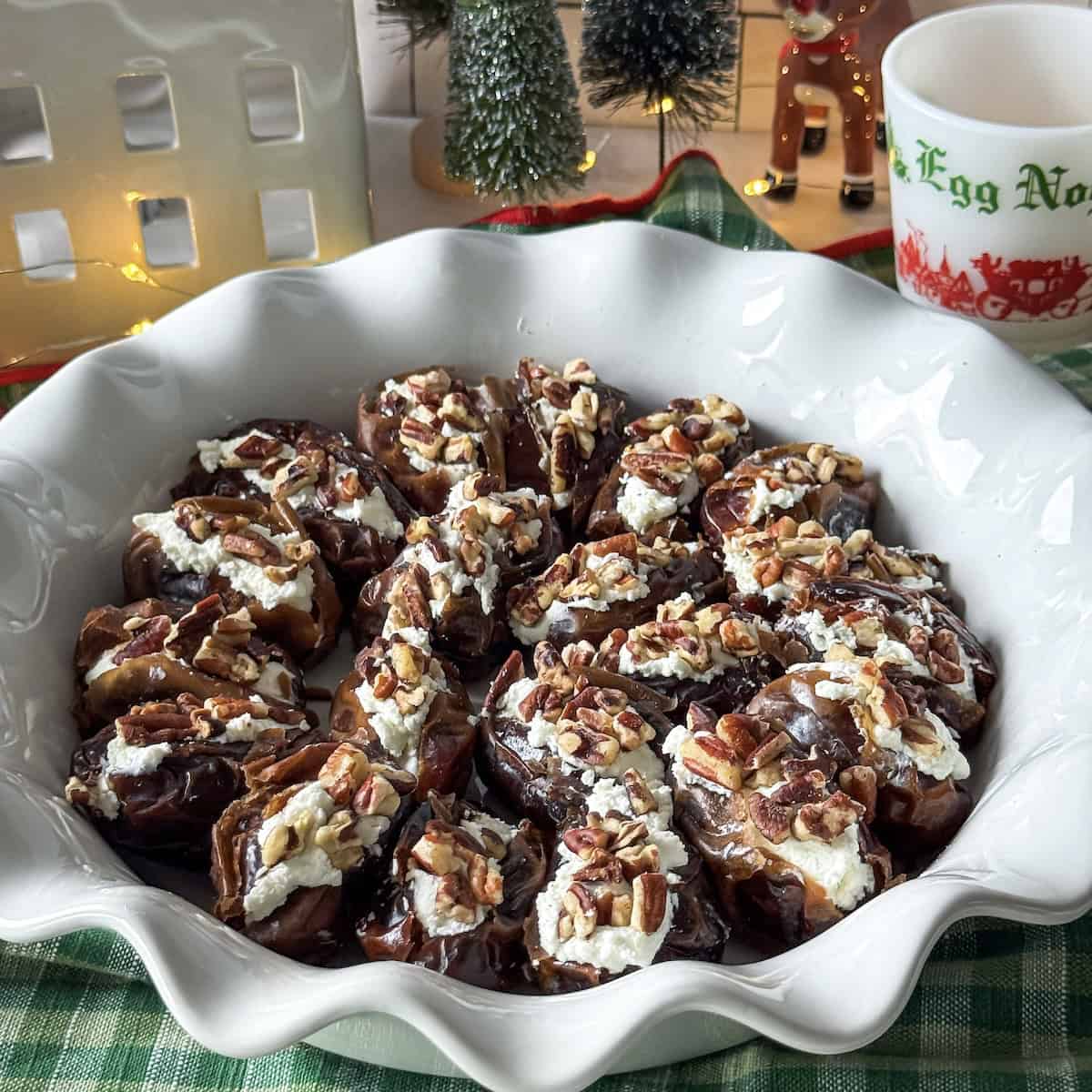 side view of goat cheese stuffed dates in a pie pan.