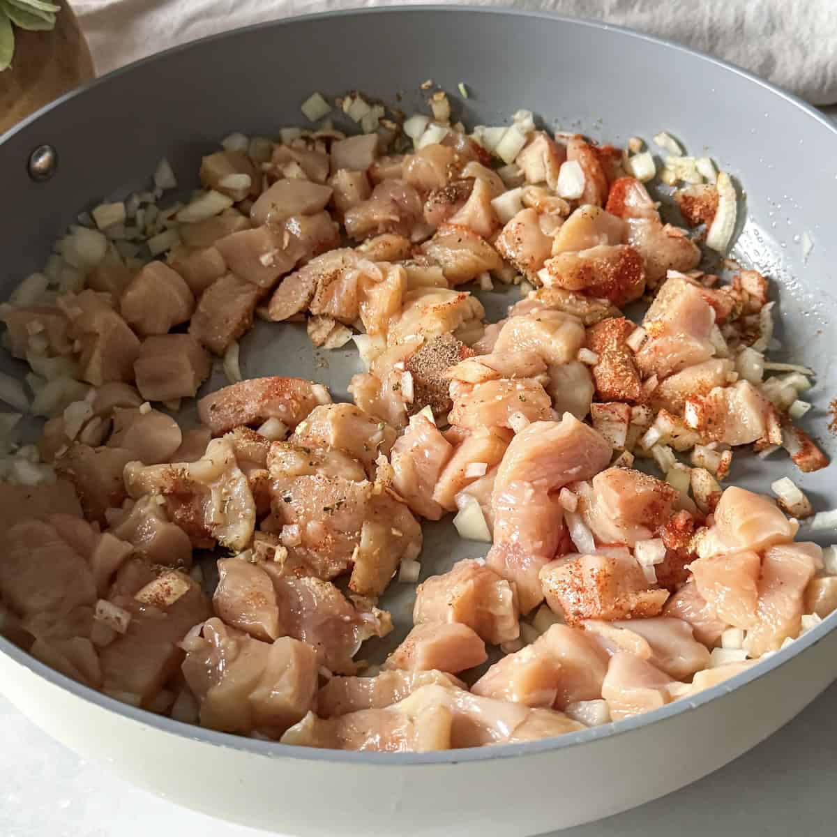 chicken and onion in a skillet.