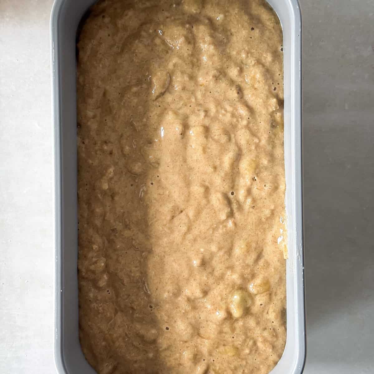 overhead view of healthy banana bread dough in a loaf pan.