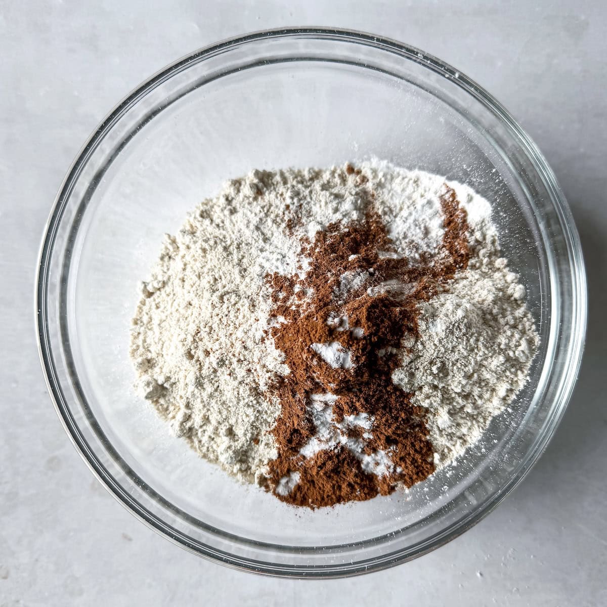overhead view of healthy banana bread dry ingredients in a glass bowl.