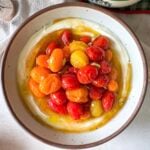 overhead view of whipped ricotta dip with roasted tomatoes on top.