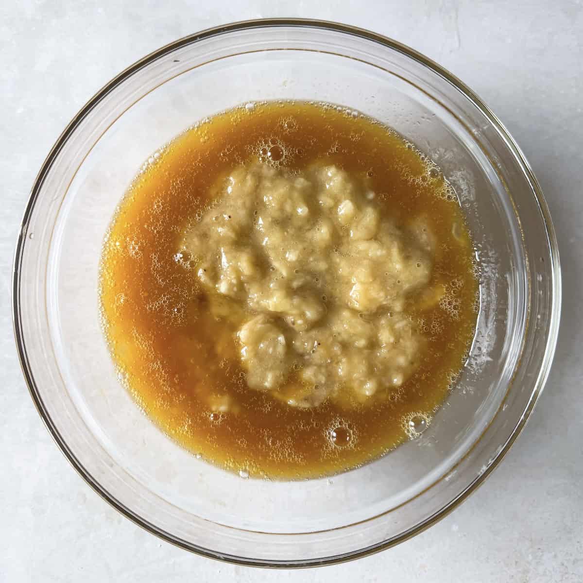 wet ingredients for banana bread in a bowl.