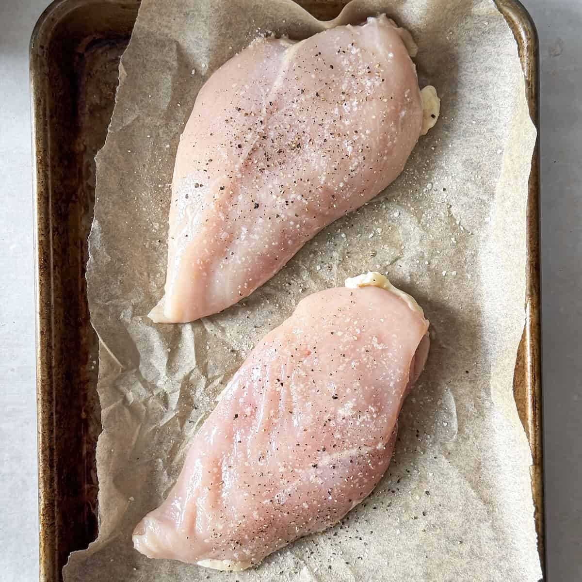 2 chicken breasts on a baking sheet.