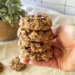 human hand holding a stack of breakfast cookies.