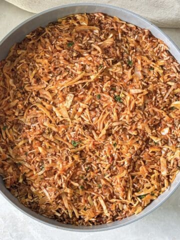 overhead view of unstuffed cabbage rolls skillet.