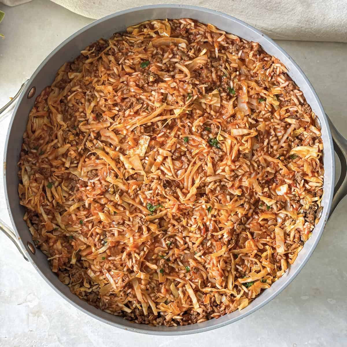 overhead view of unstuffed cabbage rolls skillet.