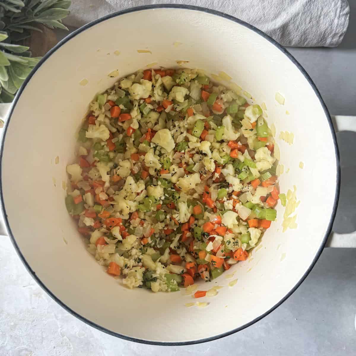 overhead view of chicken pot pie ingredients in large soup pot.