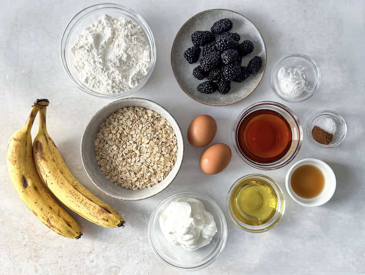 overhead view of ingredients for blackberry banana oatmeal muffins on a table.