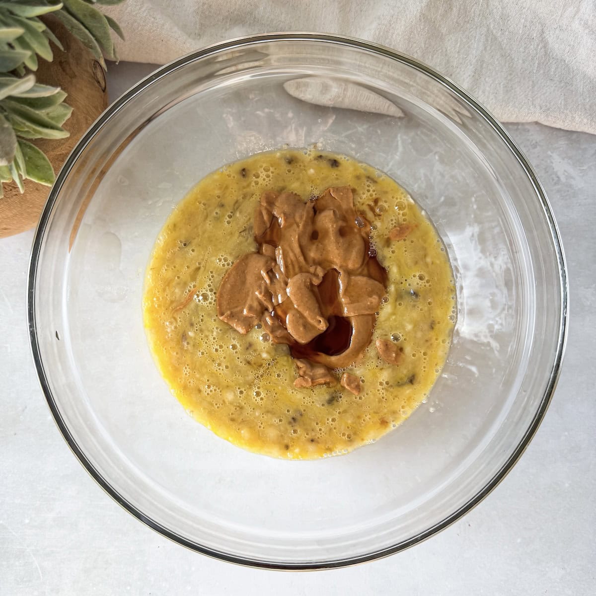 overhead view of wet ingredients in a glass bowl.