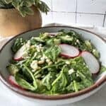 spinach and arugula salad in a bowl.