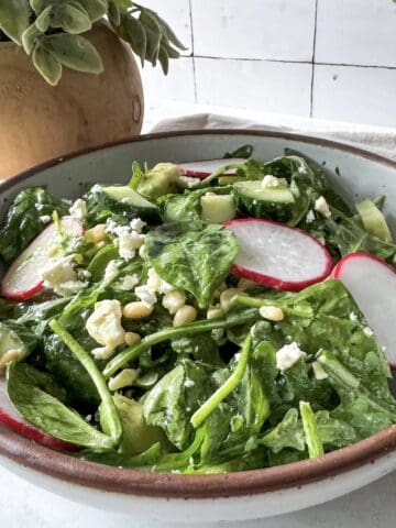 spinach and arugula salad in a bowl.