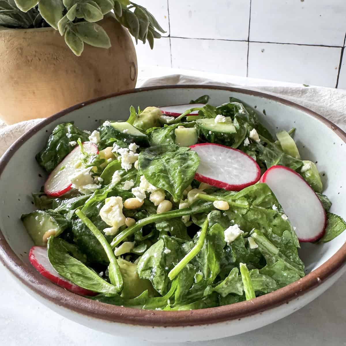 spinach and arugula salad in a bowl.