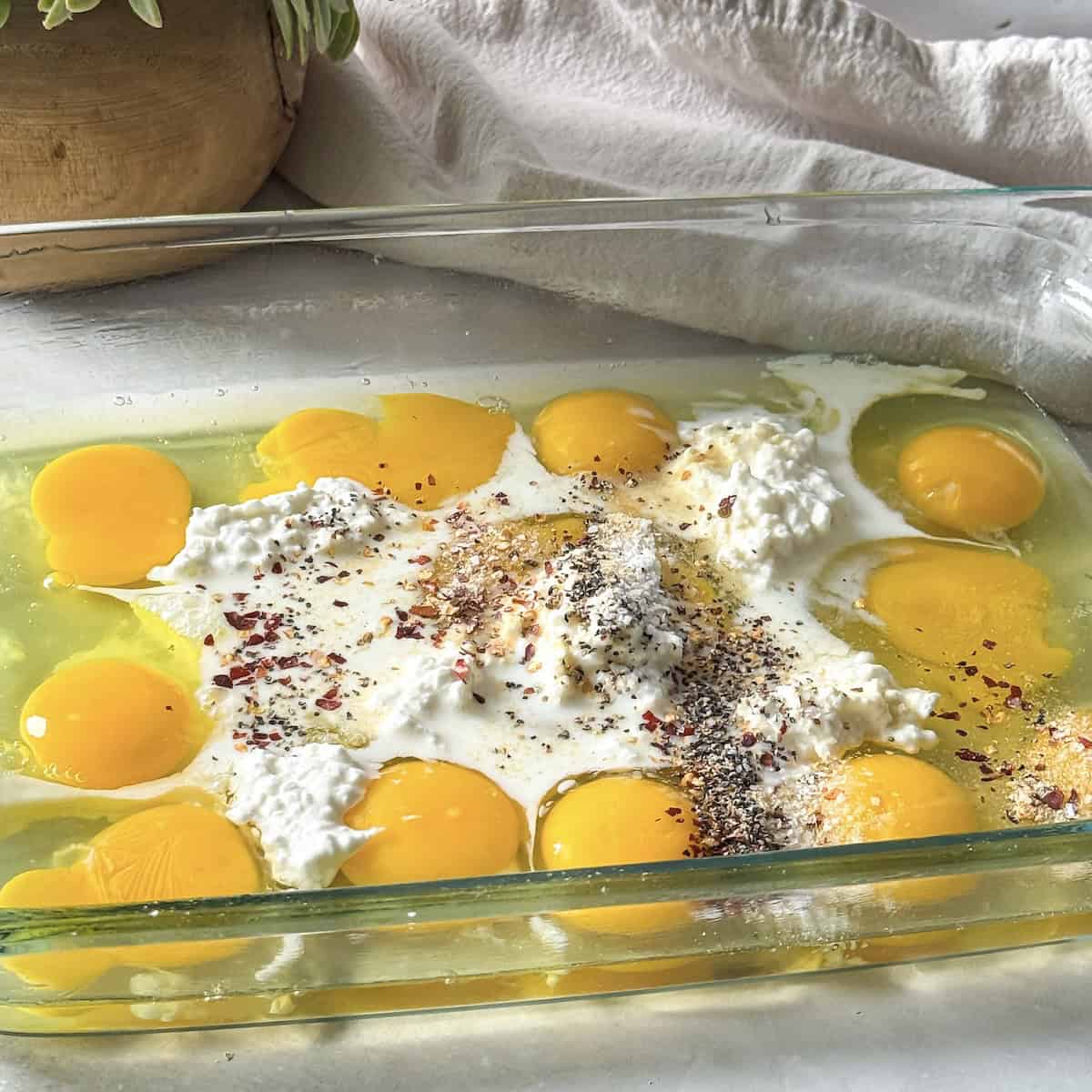 eggs, cottage cheese, milk, and seasonings in a baking dish.