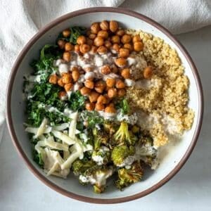 kale chickpea quinoa salad with broccoli in a bowl.