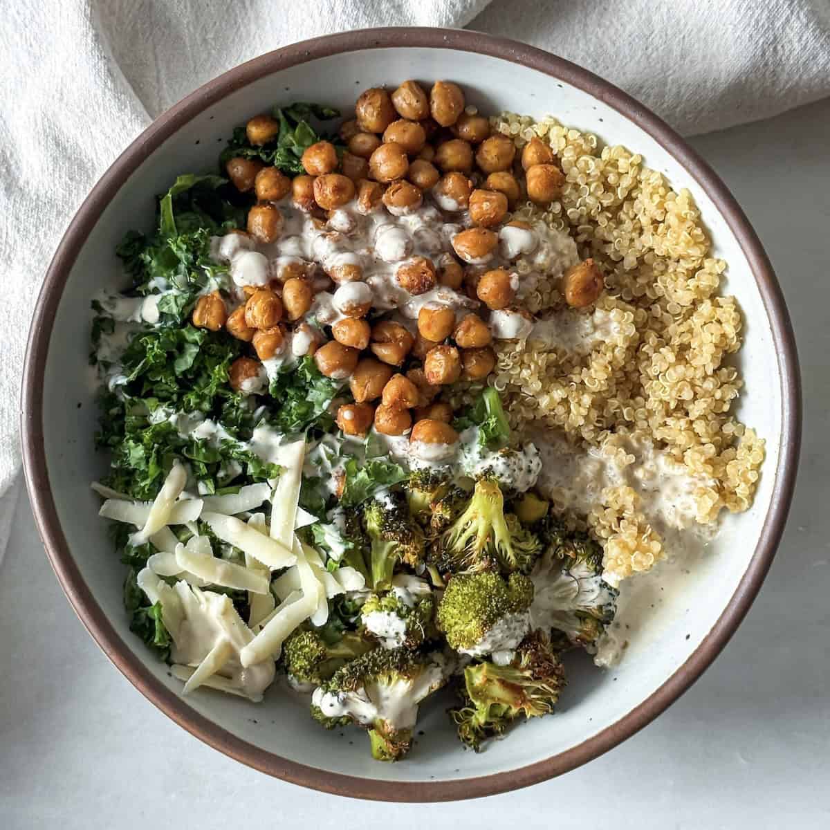 kale chickpea quinoa salad with broccoli in a bowl.