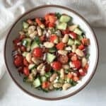 overhead view of cannellini bean salad in a bowl.